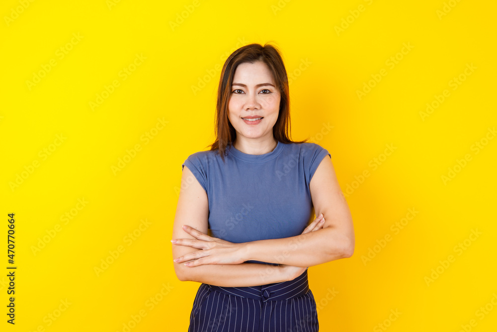 Beautiful Asian woman smiling on crop top and delighted feeling with crossed hands and looking to camera Beautiful Asian woman smiling on crop top and delighted feeling with crossed hands and looking to camera