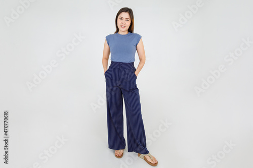 Smart Asian woman confidently standing with hands in trouser pocket and lovely smile with convinced on casual outfit lifestyle