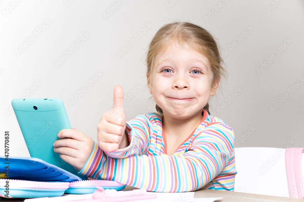 Child and Online Education on a Tablet. Child and gadget. Watching cartoons, reading, chatting, listening to music, playing on your tablet. Modern technologies Child and Online Education on a Tablet. Child and gadget. Watching cartoons, reading, chatting, listening to music, playing on your tablet. Modern technologies