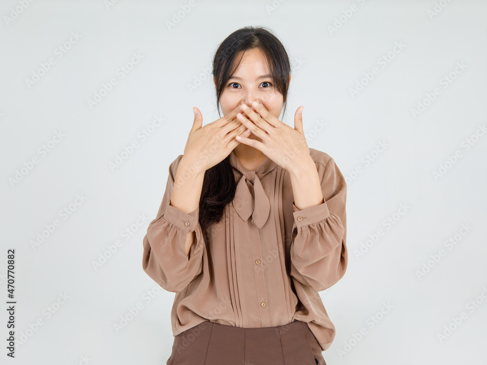 Naughty Asian girl close mouth by hands as exciting on unspoken happy news and surprising on unexpected secret sign that shock emotion Naughty Asian girl close mouth by hands as exciting on unspoken happy news and surprising on unexpected secret sign that shock emotion
