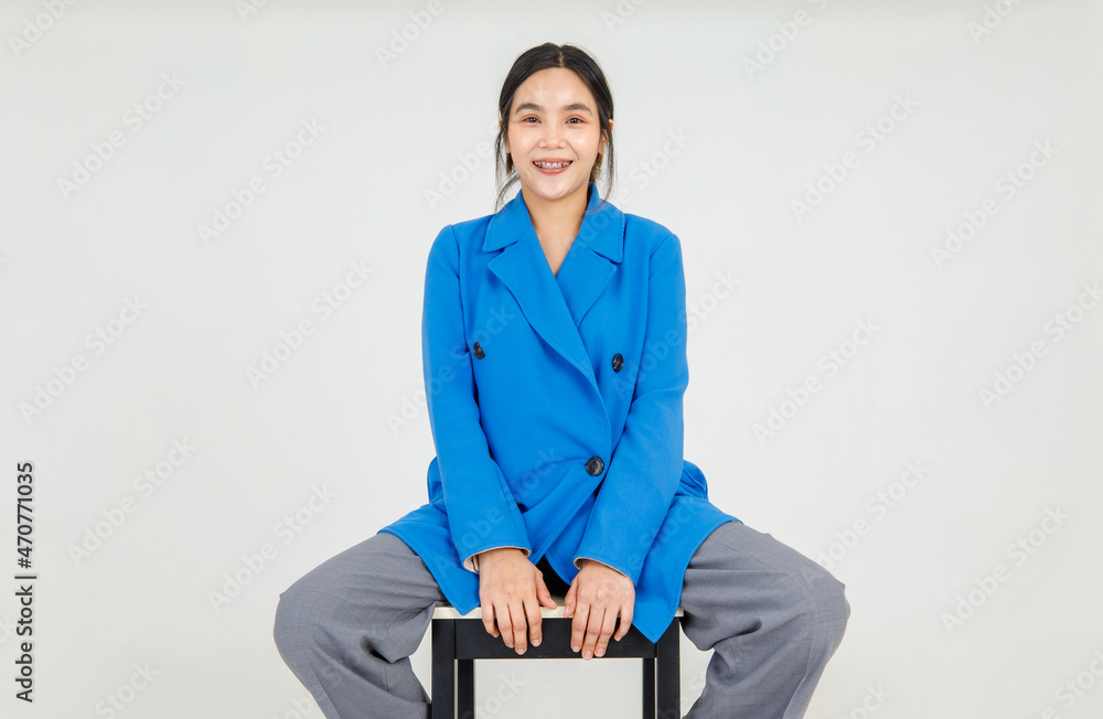Playful cute Asian girl on costume of blue jacket easily sitting on chair and cheerfully smile as enjoy outfit fashion posing of relaxation and leisure amusement Playful cute Asian girl on costume of blue jacket easily sitting on chair and cheerfully smile as enjoy outfit fashion posing of relaxation and leisure amusement