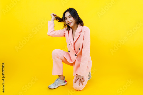 Slika na platnu Beautiful Asian lady on gorgeous pink suit pose to camera with happy action