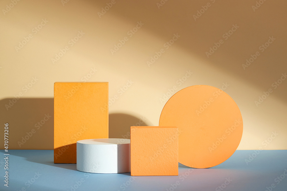 Front view of white and orange podium with and flower in a beige background for advertising , abstract content Front view of white and orange podium with and flower in a beige background for advertising , abstract content