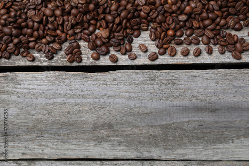 Roasted coffee beans on wooden table, flat lay. Space for text