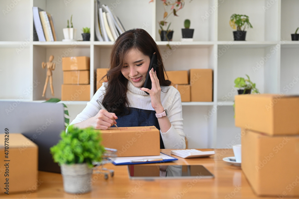Start up small business entrepreneur confirming orders from customer on mobile phone. Start up small business entrepreneur confirming orders from customer on mobile phone.
