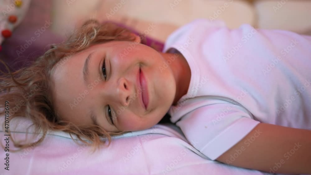 Handsome little boy smiling at camera. Child smile portrait lying down Handsome little boy smiling at camera. Child smile portrait lying down
