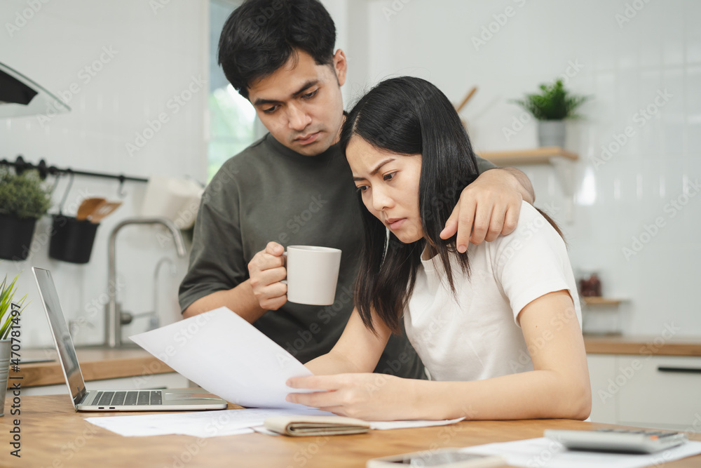 Stressed asian young couple family, wife and husband confused by calculate expense from invoice or bill, have no money to pay. Mortgage, loan causing debt, bankruptcy. Debt problems, Financial people. Stressed asian young couple family, wife and husband confused by calculate expense from invoice or bill, have no money to pay. Mortgage, loan causing debt, bankruptcy. Debt problems, Financial people.