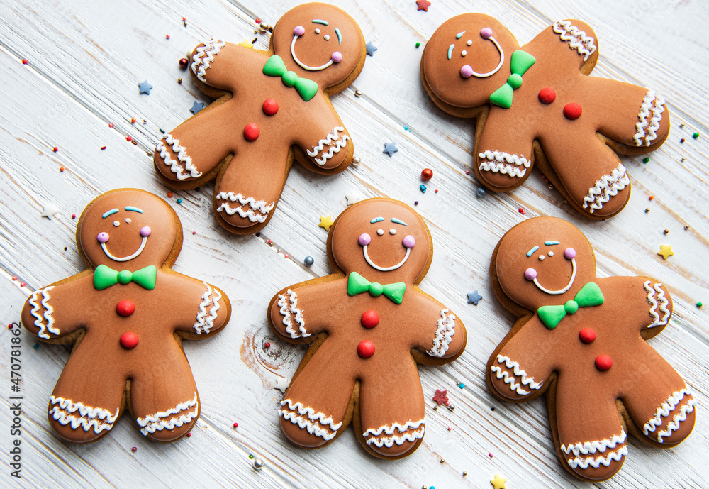 Christmas gingerbread men  on a white wooden background.