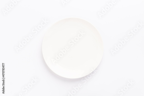 Empty ceramic round plate isolated on white background