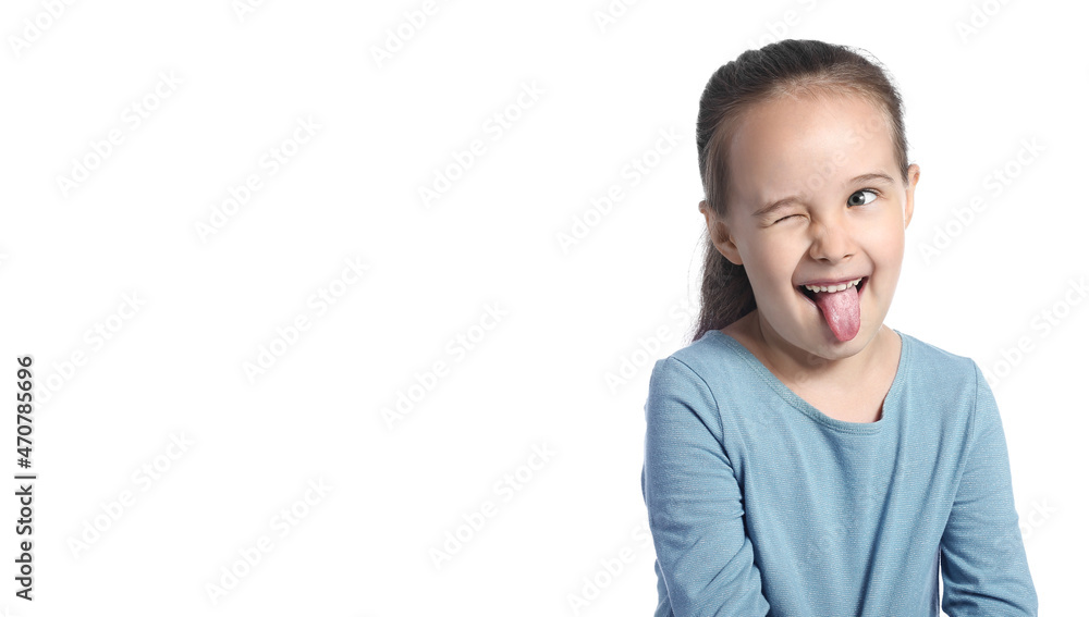 Funny little girl showing tongue on white background