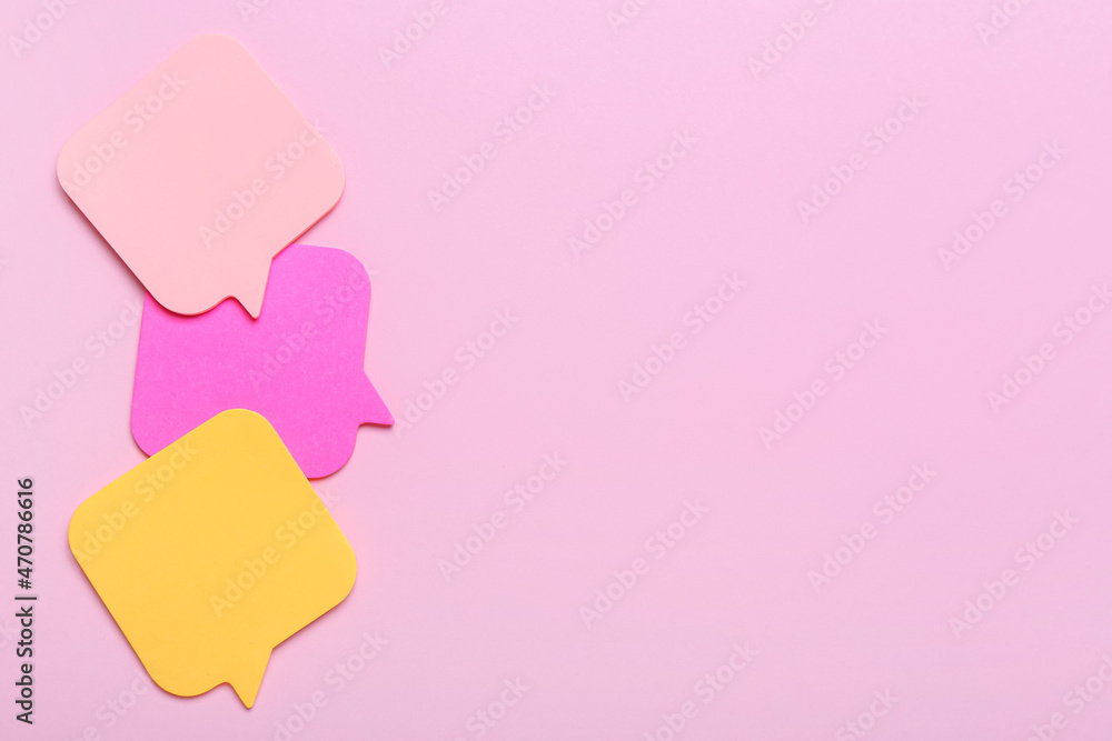 Different sticky note papers on pink background