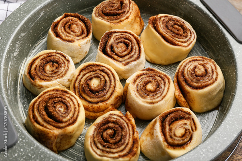 Baking dish of uncooked cinnamon rolls on table, closeup