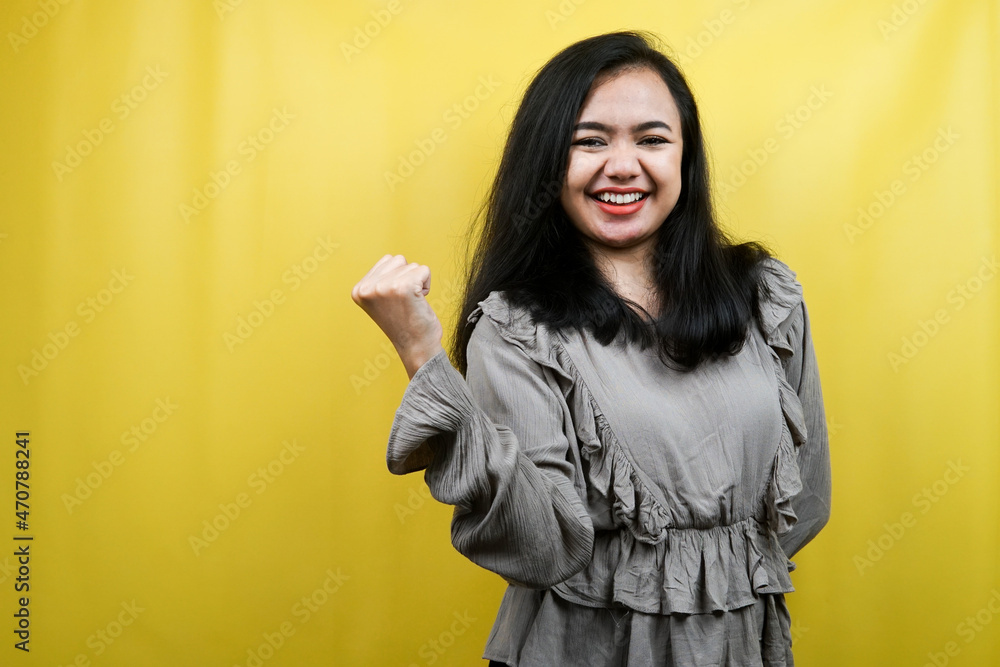 Beautiful young woman with clenched fists, success, good work, victory, cheerful and confident, isolated Beautiful young woman with clenched fists, success, good work, victory, cheerful and confident, isolated