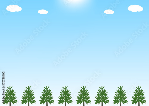 太陽の光と青空と針葉樹森の背景