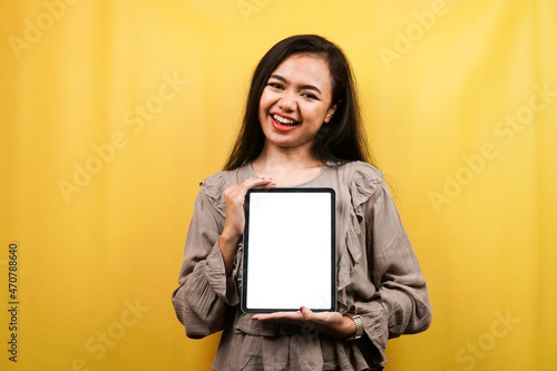 Beautiful young woman hands holding tablet with blank or white screen, presenting something, promoting product, cheerful and confident, advertisement, isolated