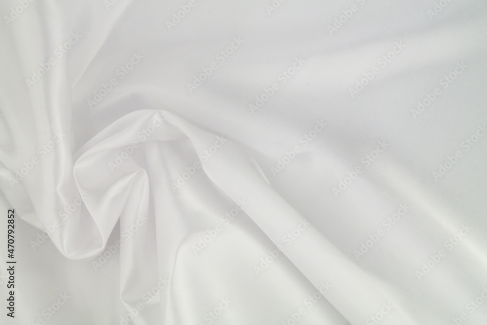 Fototapeta premium White satin or silk fabric as background. Elegant wallpaper, wedding backdrop or design element. 