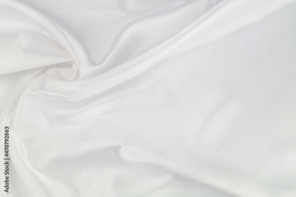 White satin or silk fabric as background. Elegant wallpaper, wedding backdrop or holidays design element. 