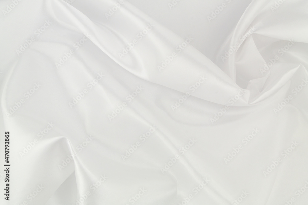 Fototapeta premium White satin or silk fabric as background. Elegant wallpaper, wedding backdrop or design element. 