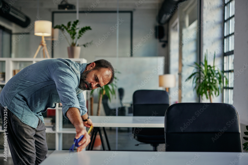 Fototapeta premium Businessman taking care about protection measures at work during pandemic