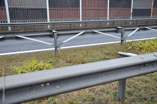 connection of metal and concrete highway barriers with screws. reinforcement with metal struts and tensioned bars in places where there is not enough space between the lanes. noise barrier © Michal
