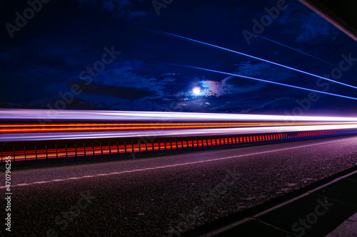 lights of cars with night. long exposure, moon and sky