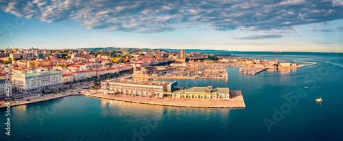 View from flying drone of quay of Trieste city, Italy, Europe. Panoramic morning view of Tourist attraction - Cruise Pier Trieste with Molo Teresiano on background. Traveling concept background. photo