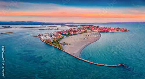 Beautiful summer scenery. Breathtaking summer view  from flying drone of public beach of Grado port, small town located between Venice and Trieste. Magnificent evening seascape of Adriatic sea. photo