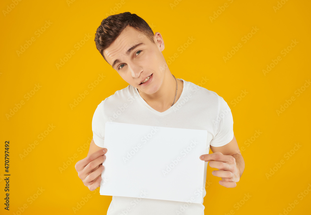 Cheerful man in white t-shirt sheet of paper copy space advertisement Cheerful man in white t-shirt sheet of paper copy space advertisement