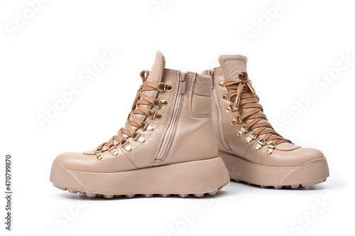Womens beige leather boots with zip and lacing, photographed against a white background.
