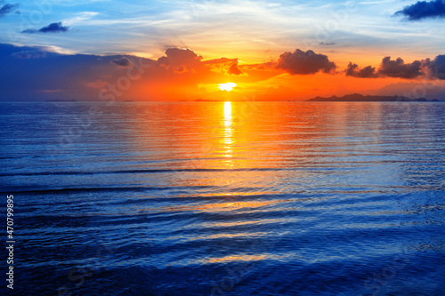 Colorful sea sunset view  bright ocean sunrise  yellow golden sun glow reflection  blue water waves  red orange sky  cloud  beautiful tropical island coast landscape  summer holidays  vacation  travel