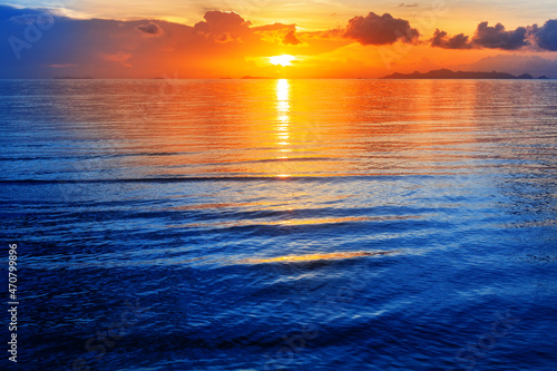 Colorful sea sunset view  bright ocean sunrise  yellow golden sun glow reflection  blue water waves  red orange sky  cloud  beautiful tropical island coast landscape  summer holidays  vacation  travel