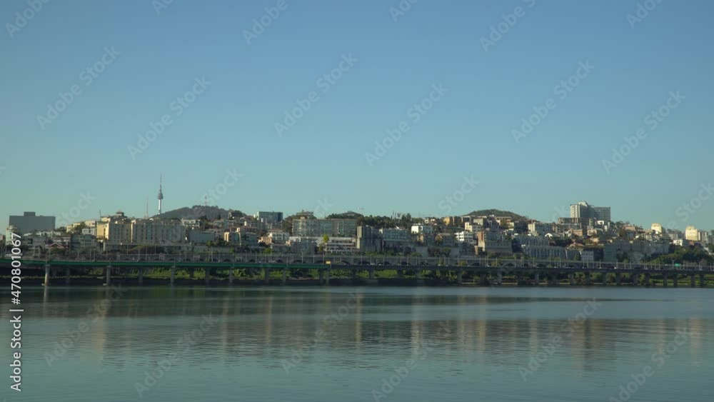 Seoul Skyline from Han river Park Waterfront with N Seoul Tower and Yongsan district over clear blue sky, Traffic on Gangbyeon Expressway - copy space Seoul Skyline from Han river Park Waterfront with N Seoul Tower and Yongsan district over clear blue sky, Traffic on Gangbyeon Expressway - copy space