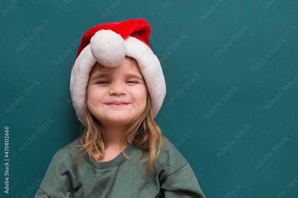 Happy child girl in Santa red hat Merry Christmas! Copy space. New Year's background.
Happy child girl in Santa red hat Merry Christmas! Copy space. New Year's background.