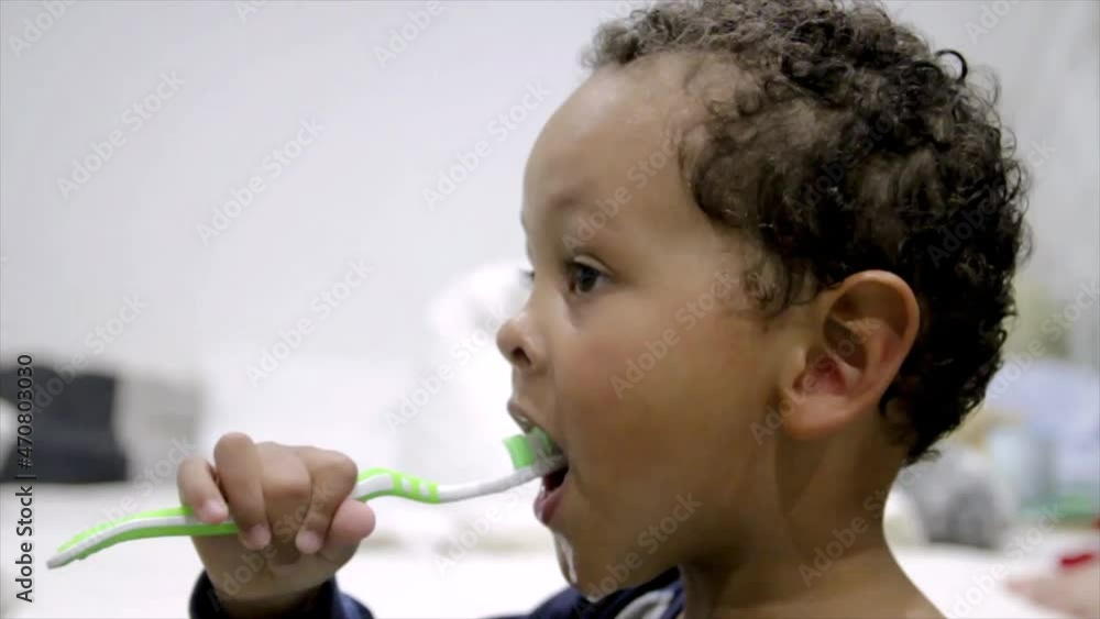 boy brushing his teeth with a tooth brush at home stock video boy brushing his teeth with a tooth brush at home stock video