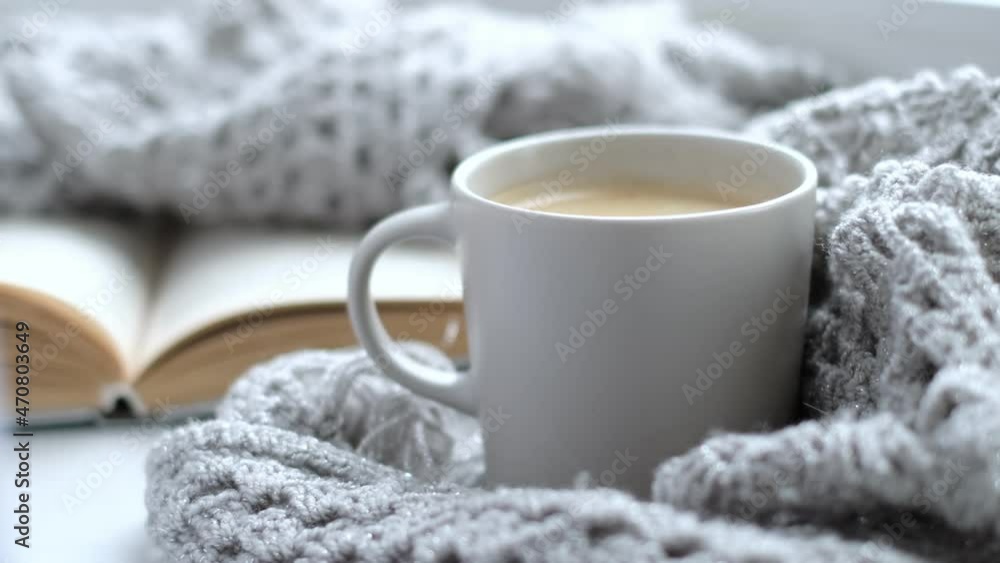 Close up video. Steaming coffee cup on a rainy day window background. cozy atmosphere, in cold weather calm background. Rainy Day Mood. selective focus, soft focus