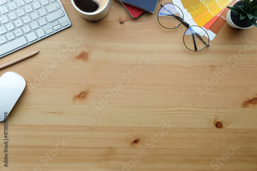 Top view female workspace with glasses  coffee cup  earphone and stationery on wooden table..