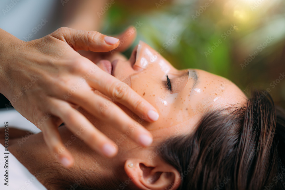Beautician Putting Beauty Face Mask on Woman’s Face Beautician Putting Beauty Face Mask on Woman’s Face