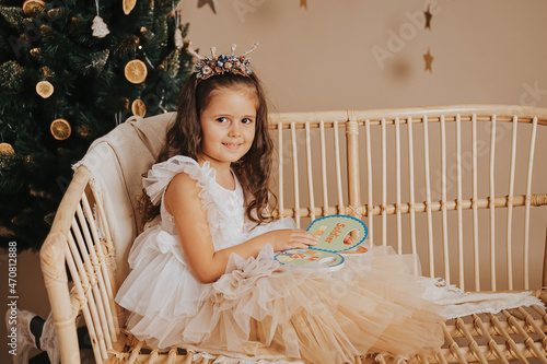 little happy girl celebrating christmas and playin photo