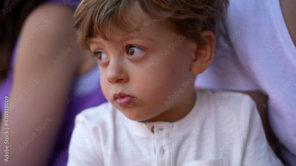 Portrait pensive little baby toddler boy child watching sport game Portrait pensive little baby toddler boy child watching sport game