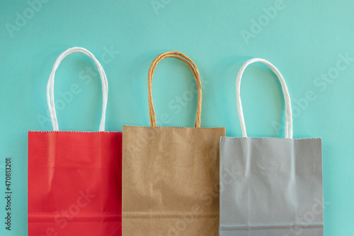 Shopping bags in a row on a colored background.