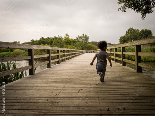 Fototapeta Naklejka Na Ścianę i Meble -  Child running on a bridge