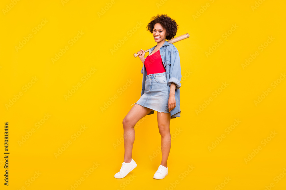 Photo of gorgeous hipster lady hold baseball bat wear denim jacket short skirt isolated yellow color background Photo of gorgeous hipster lady hold baseball bat wear denim jacket short skirt isolated yellow color background
