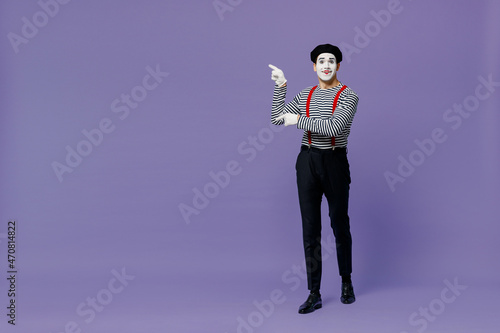 Fotografiet Full size happy young mime man with white face mask wears striped shirt beret point finger aside on workspace area copy space mock up isolated on plain pastel light violet background studio portrait