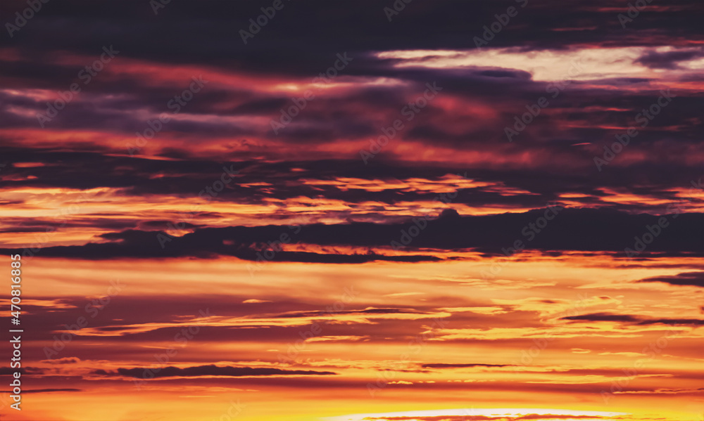 Sunset dramatic sky. Colorful twilight background. Warm light through the cloudscape. Sunset dramatic sky. Colorful twilight background. Warm light through the cloudscape.