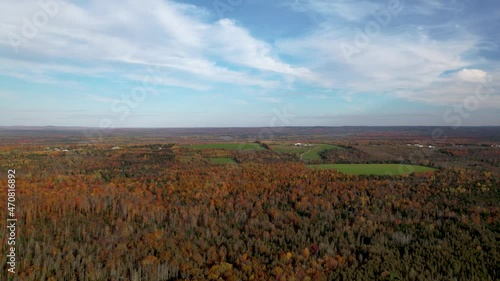 Aerial view to the autumn valley with colorful trees. Autumn background. The camera descends from a height downward overlooking the valley. Patten, Penobscot County, Maine, USA. photo