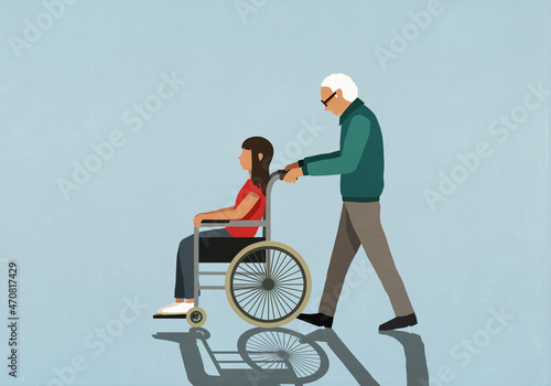 Senior man pushing girl in wheelchair
 photo