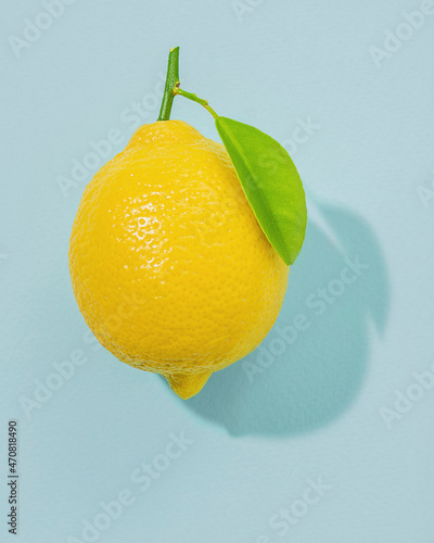 Bright yellow lemon on blue background
 photo