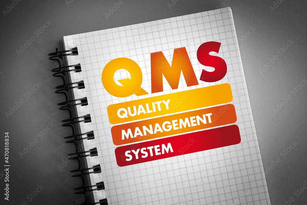 Fototapeta premium QMS - Quality Management System acronym on notepad, business concept background