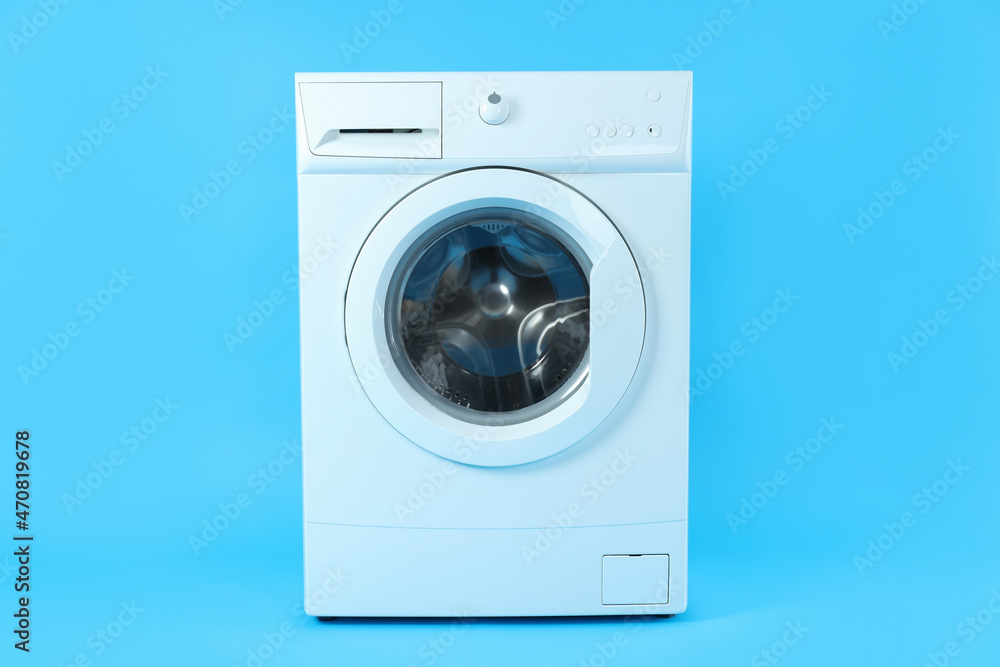 Modern white washing machine on blue background