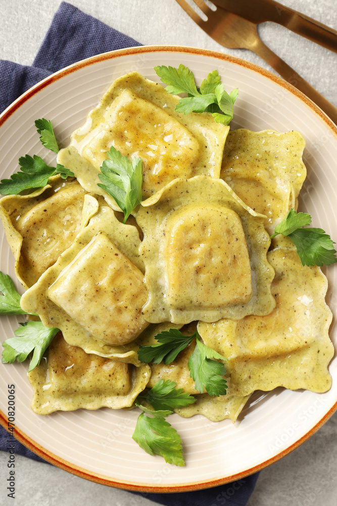Delicious food concept with ravioli on gray background